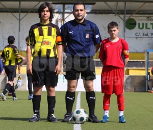 El colegiado con los capitanes del partido