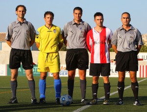 El trio arbitral con los capitanes del partido