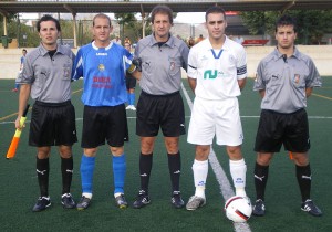 El trio arbitral con los capitanes del partido