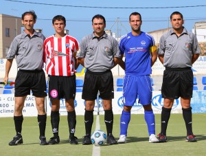 El trio arbitral con los capitanes del partido