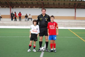 El colegiado con los capitanes del partido