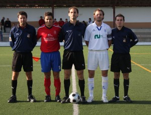 El trío arbitral con los capitanes del encuentro