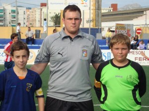 El colegiado con los capitanes del partido