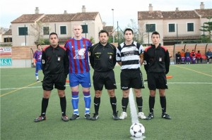 El trío arbitral con los capitanes del partido