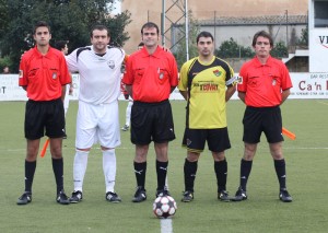 El trío arbitral con los capitanes del partido