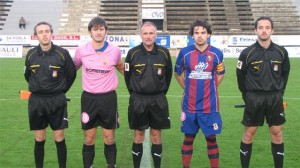 El trío arbitral con los capitanes del partido