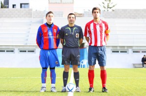 El colegiado con los capitanes del partido