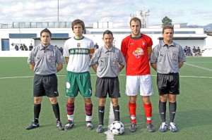 El trio arbitral con los capitanes del partido