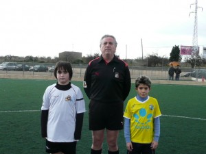 El colegiado con los capitanes del partido