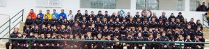 Los futbolistas y entrenadores del club del municipo de Sant Joan posan en las gradas del estadio en el que entrenan y juegan sus partidos. LUIS HERRERA