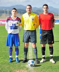 El colegiado con los capitanes del partido