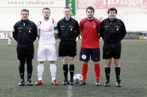 El trio arbitral con los capitanes del partido