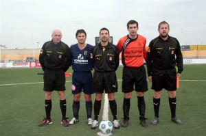 El trio arbitral con los capitanes del partido