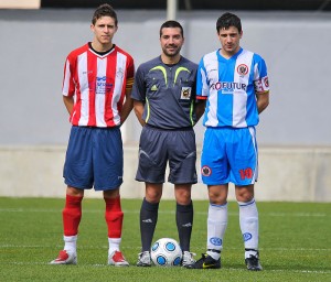 El colegiado con los capitanes del partido